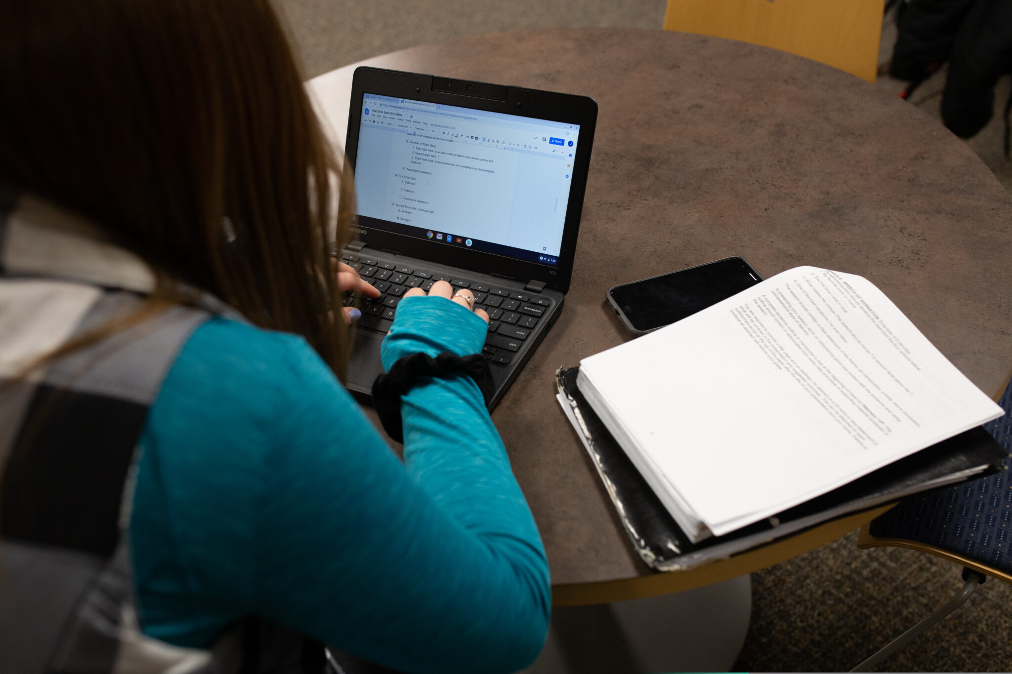 Teenage female student at her laptop - article about online dual enrollment for homeschoolers
