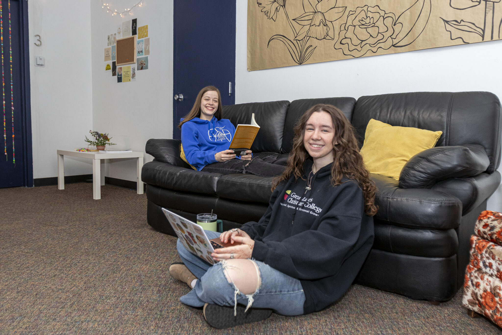 Happy female students studying in a dorm room at a good Christian college
