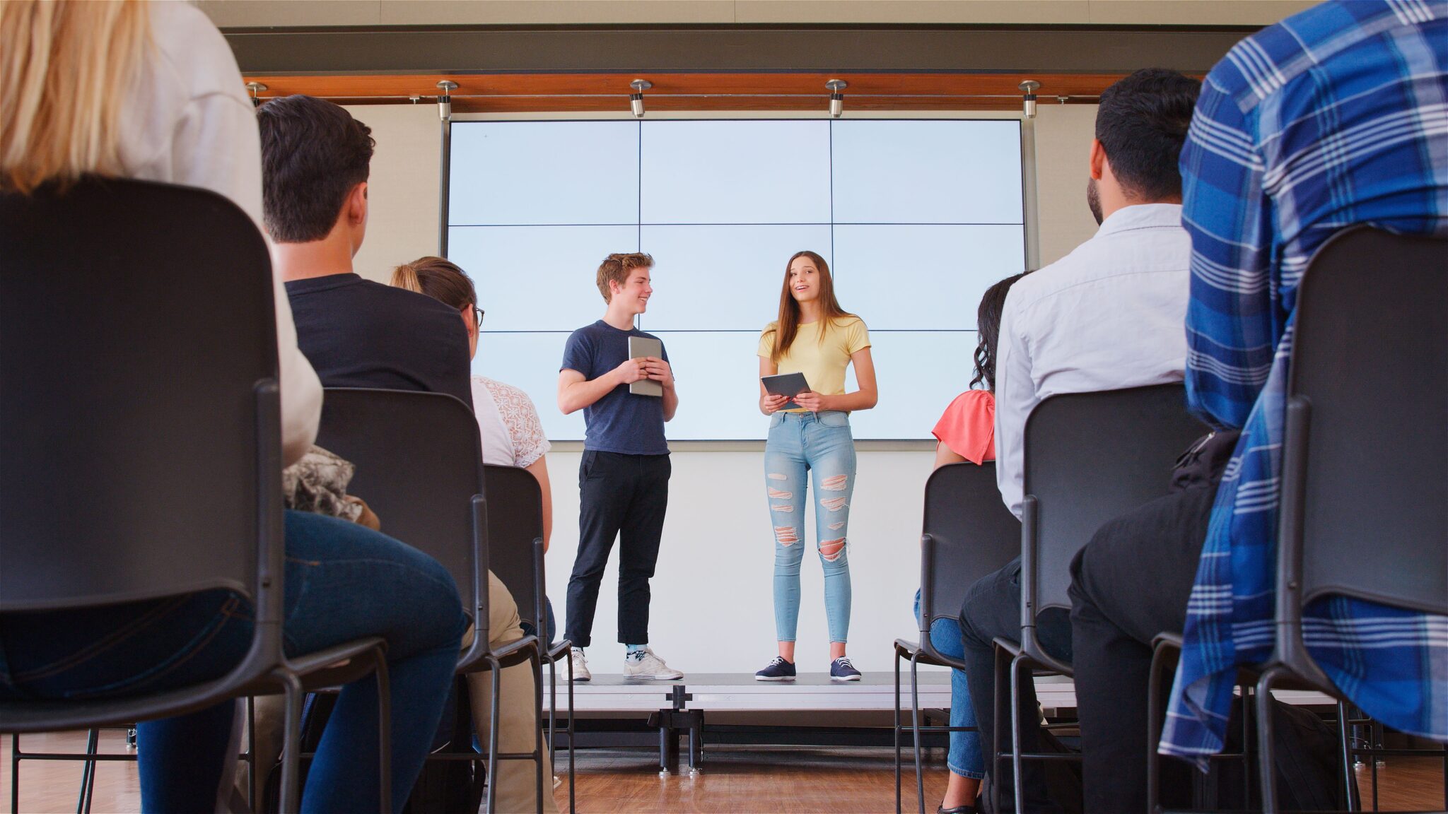 Two college students enrolled in a Christian business school giving a presentation
