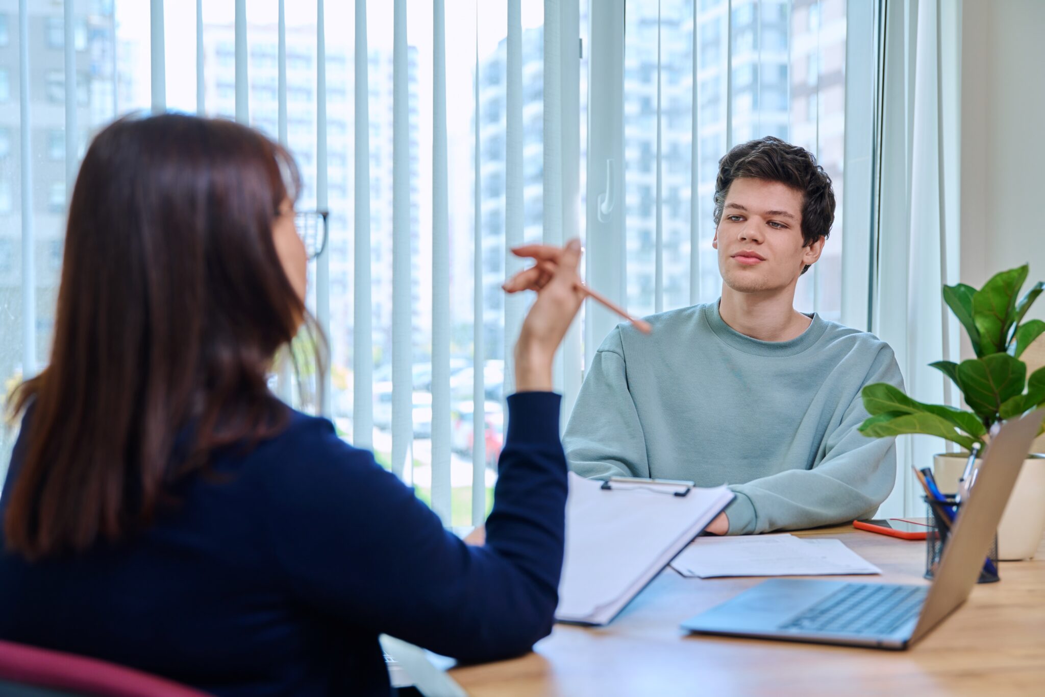 two people seated at a table in discussion