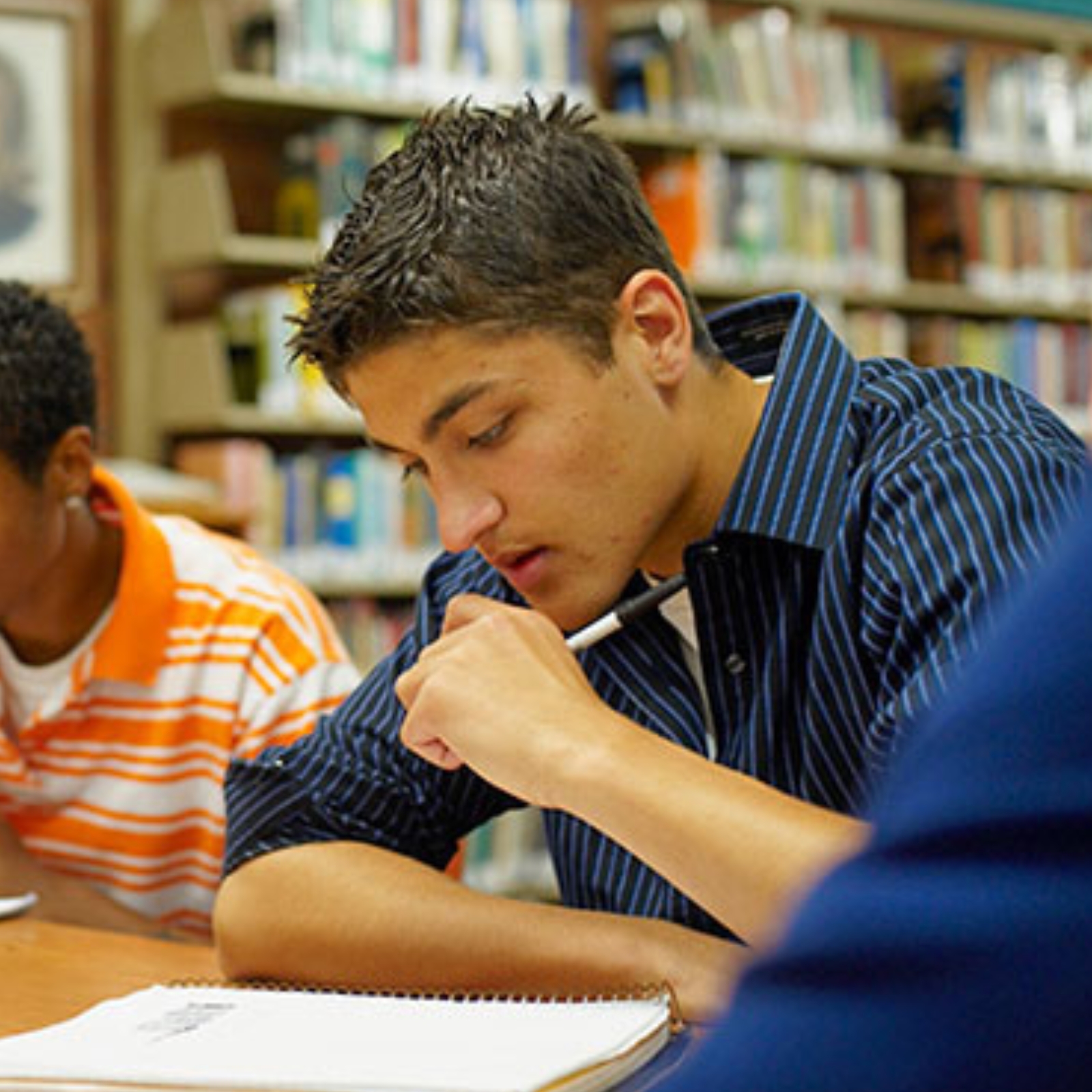 boy studying in library facing left