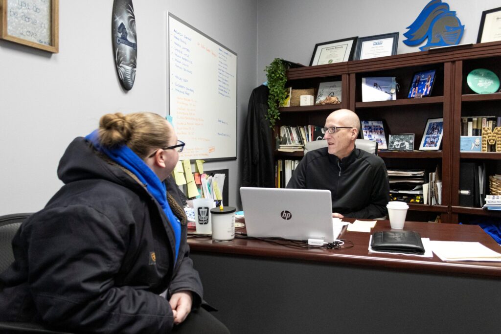 Professor meets in office with student